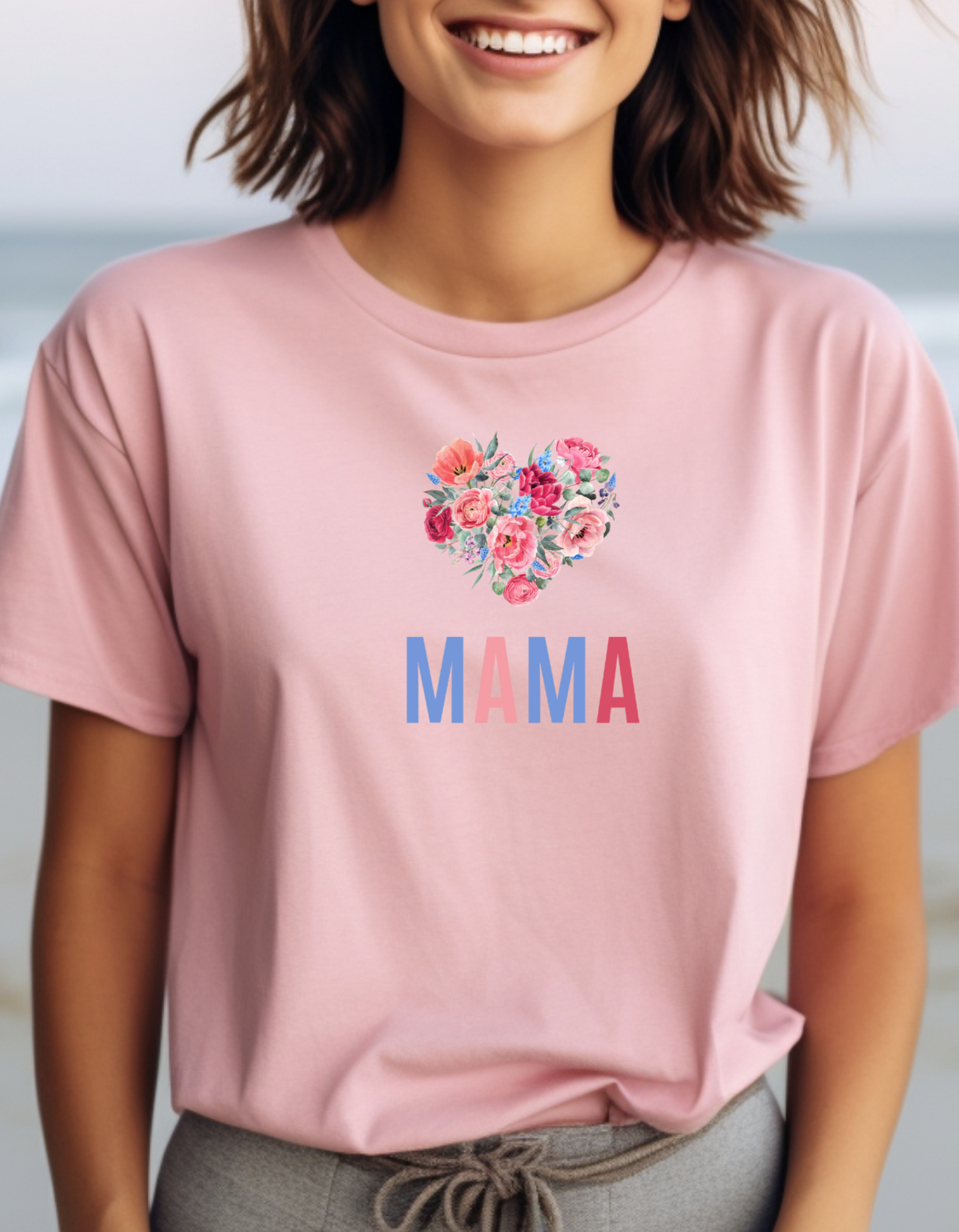 Celebrate Mother's Day with our vibrant "MAMA" t-shirt featuring colorful fonts and a heart-shaped bouquet of flowers. Perfect gift for mom.