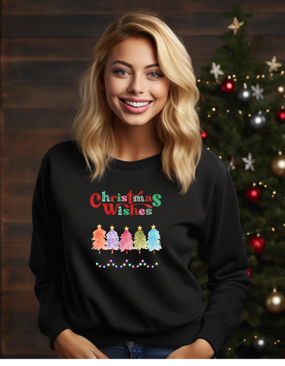 Woman wearing a black sweatshirt with 'Christmas Wishes' and Christmas tree design in front of a decorated Christmas tree.