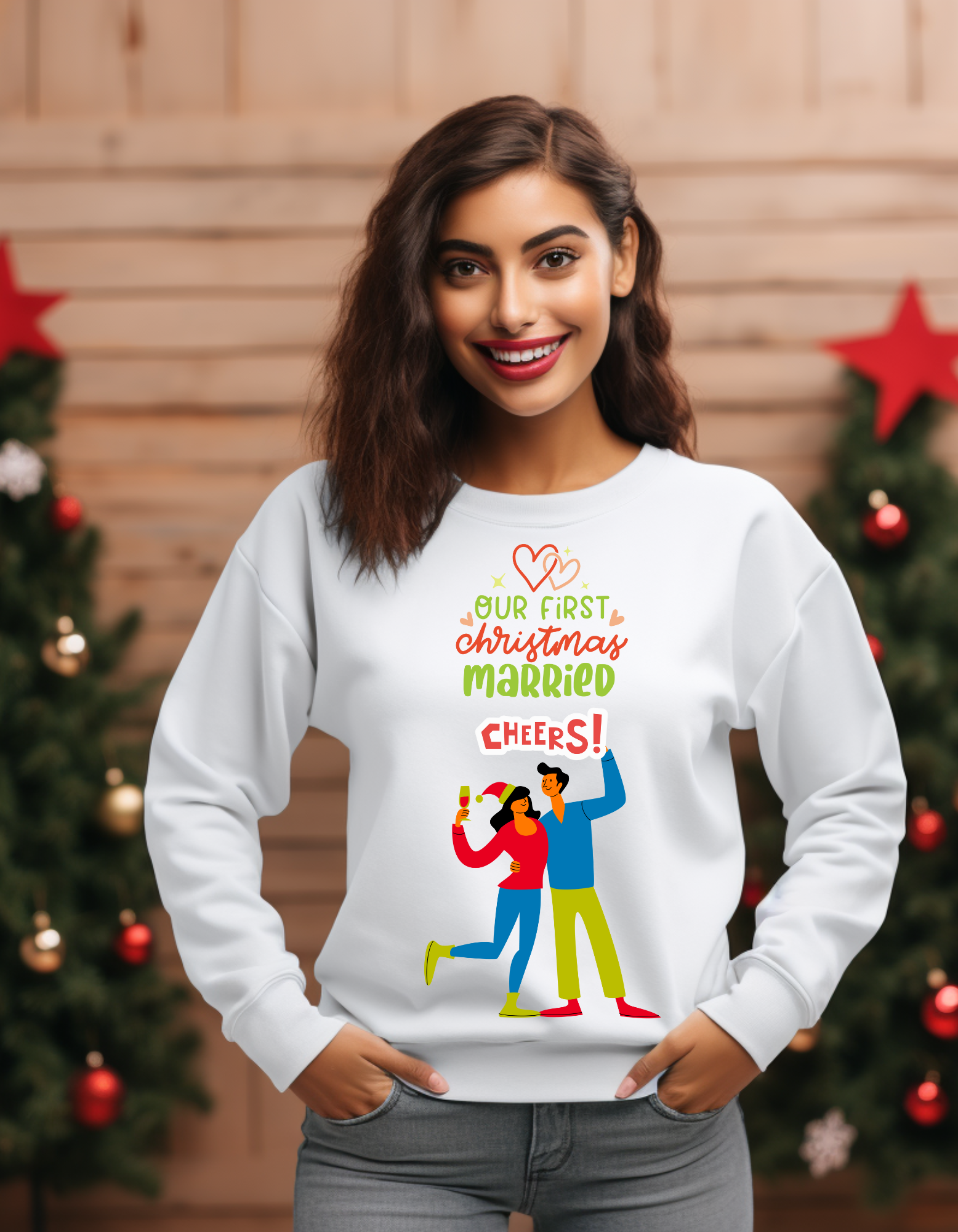 Woman wearing a white sweatshirt with Christmas-themed text and graphics, standing in front of a decorated Christmas tree.