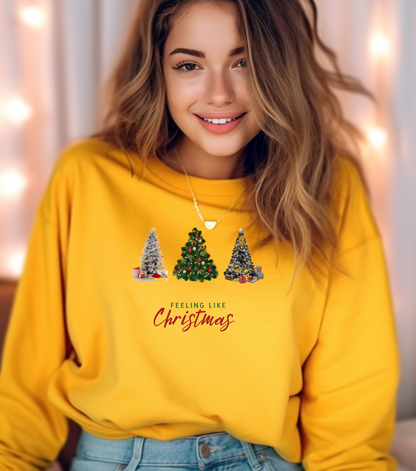 Woman wearing a yellow sweatshirt with Christmas tree design and text.