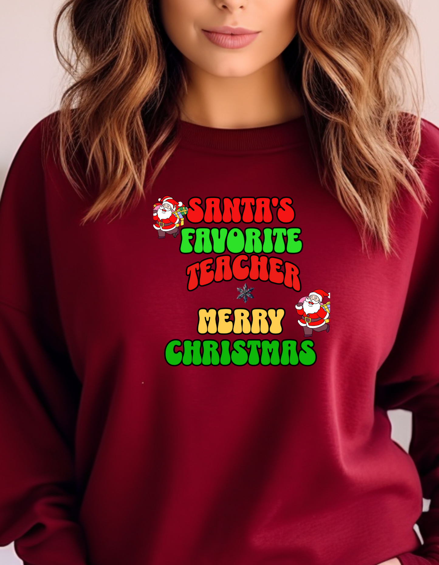 Red sweatshirt with Christmas-themed text and graphics worn by a person.